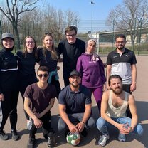 Team photo after a football game with volunteers at the center and local community members.